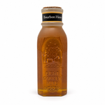 Honey Feast Bourbon 8oz Muth glass honey gift jar with a natural tapered cork, hand-dipped beeswax finish and matte yellow-bordered neck label, front view on white.
