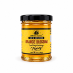 Honey Feast Orange Blossom Honey in a small 3oz glass jar on a white background