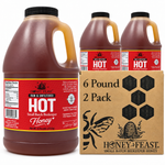 Honey Feast Hot honey 2-pack of 6lb frosted HDPE plastic jugs with wide black screw caps, shown with the branded shipping carton on a white background.