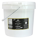 Honey Feast Manuka Infused Honey with Propolis, 2-gallon bucket containing 24 pounds of honey, closed-lid front view on white.