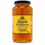 Honey Feast Wildflower Honey – 3lb Glass Jar filled with honey, black screw lid, on a white background