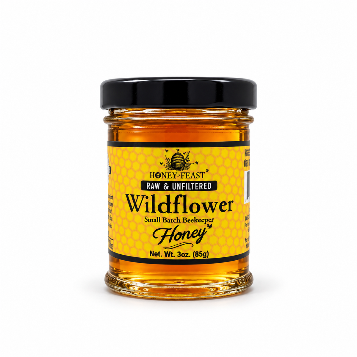 Honey Feast Wildflower Honey in a small 3oz glass jar on a white background