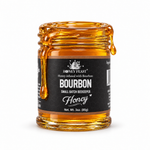 Bourbon honey coating the rim and dripping down an open 3oz Honey Feast glass jar