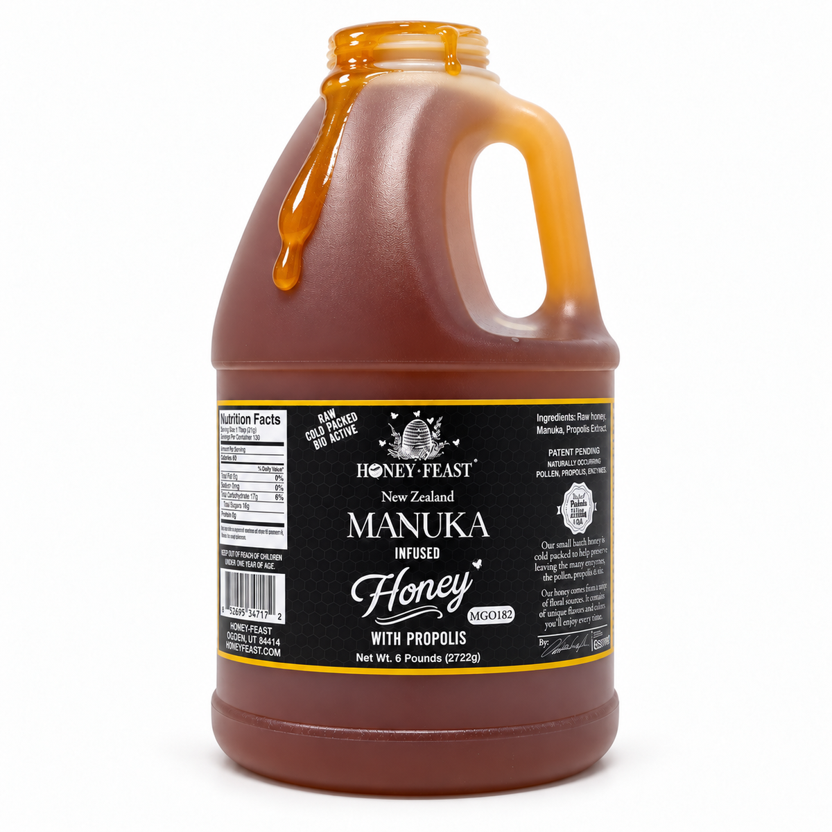 Honey Feast Manuka Infused with Propolis 6lb bulk honey in a frosted HDPE plastic jug with the handle on the right, with honey dripping over the open rim on a white background.
