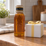 Honey Feast Orange Blossom Honey 8oz Muth glass gift jar with a cork and hand-dipped beeswax finish, in a simple gifting scene.