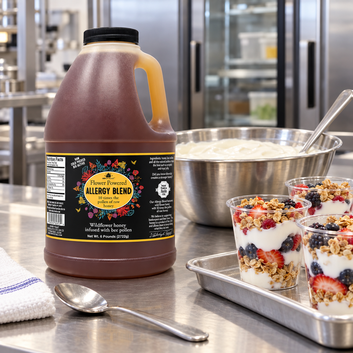 Honey Feast Allergy Blend 6lb bulk honey in a frosted HDPE plastic jug with the handle on the right, commercial parfait prep.