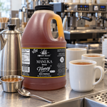 Honey Feast Manuka Infused with Propolis 6lb bulk honey in a frosted HDPE plastic jug with the handle on the right, commercial tea station.