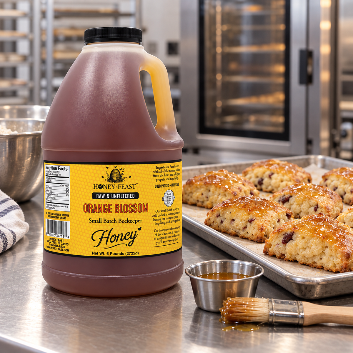 Honey Feast Orange Blossom 6lb bulk honey in a frosted HDPE plastic jug with the handle on the right, commercial bakery prep.