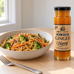 Ginger Honey glass jar beside homemade honey ginger vegetable stir-fry noodles