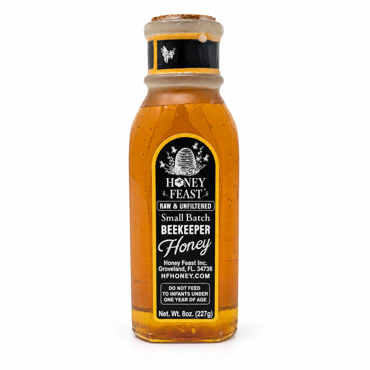 Back label of Honey Feast Orange Blossom Honey 8oz Muth glass gift jar, showing the Honey Feast label, net weight and infant warning.