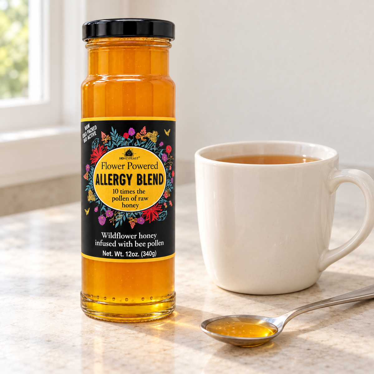 Honey Feast Allergy Blend Honey 12oz glass jar beside a cup of tea