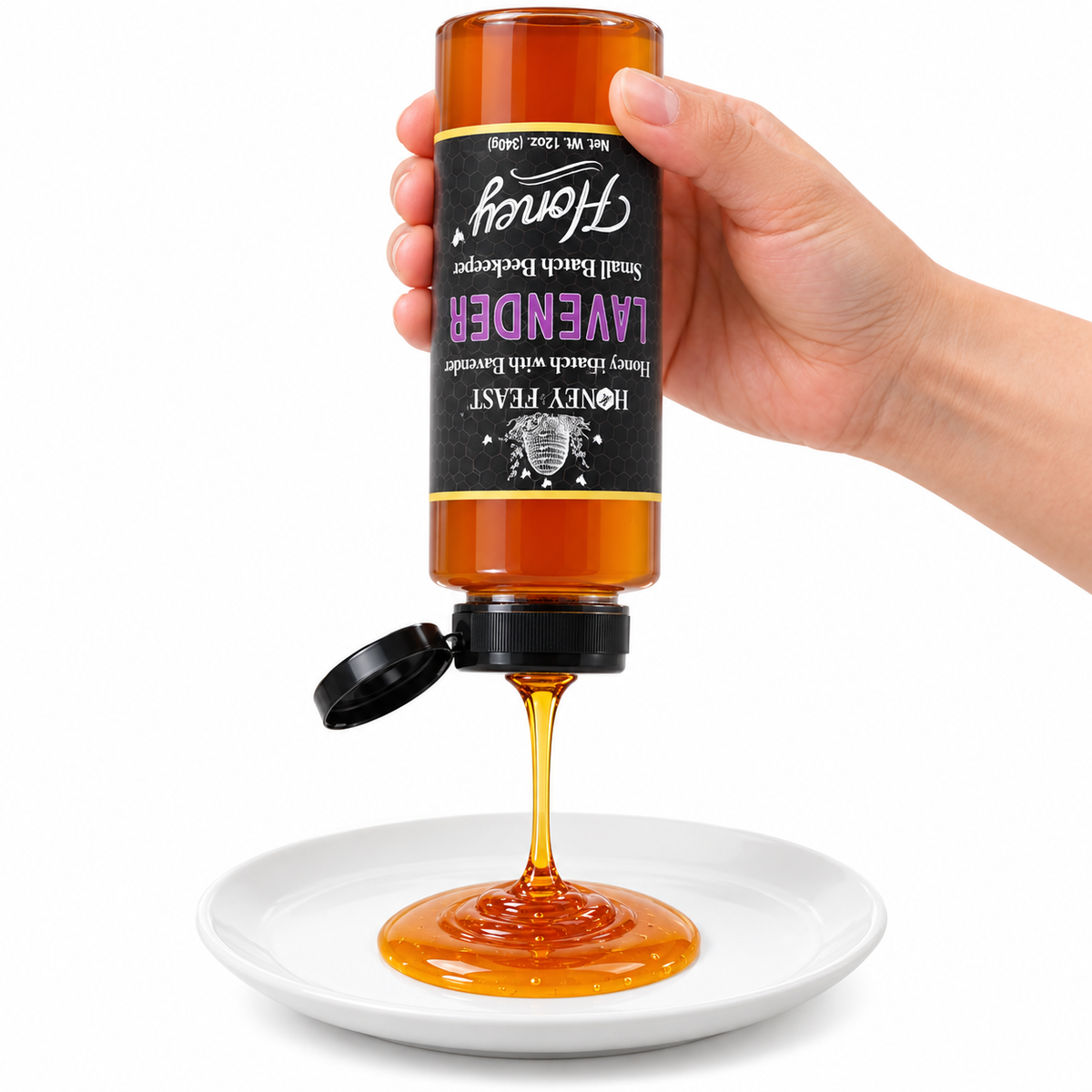 Hand squeezing an inverted Lavender Honey 12oz plastic bottle onto a white plate with the flip-top lid open and label correctly upside down