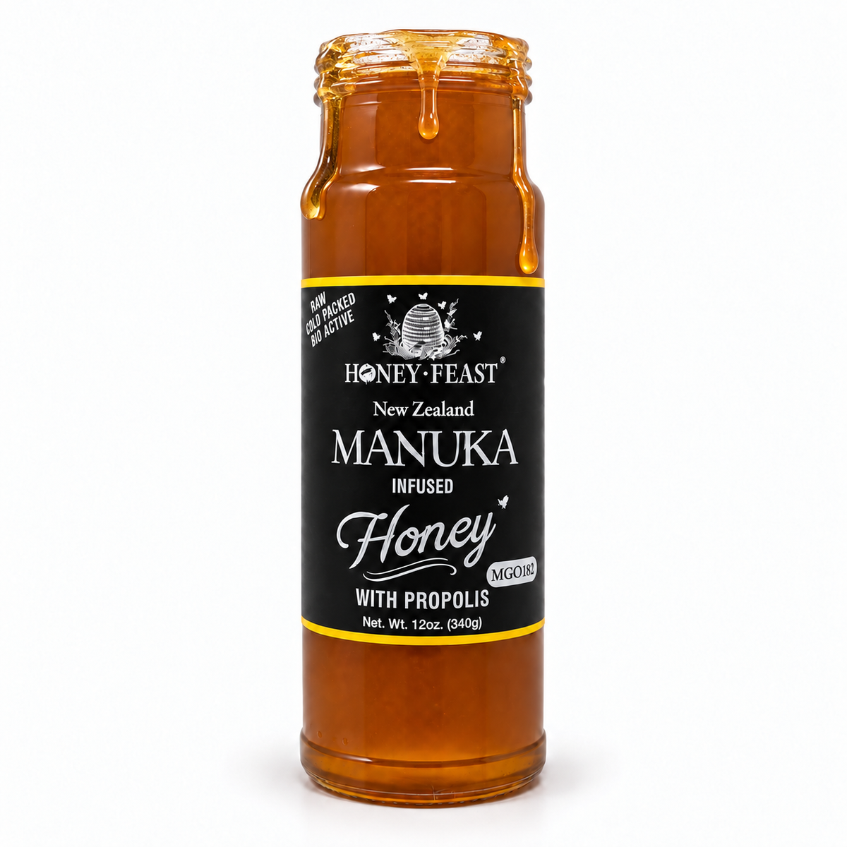 Honey Feast Manuka infused honey with propolis in an open 12oz glass jar with honey dripping down the side