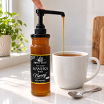 Honey Feast Manuka infused honey 12oz glass jar with optional honey pump beside tea; pump sold separately