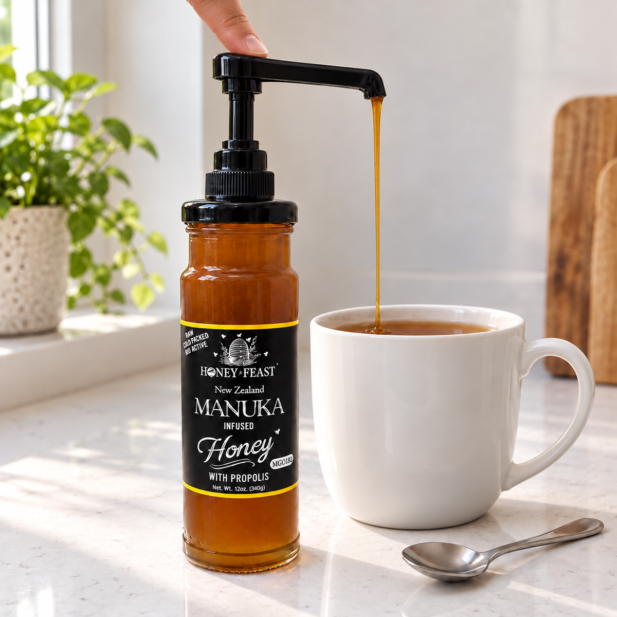 Honey Feast Manuka infused honey 12oz glass jar with optional honey pump beside tea; pump sold separately