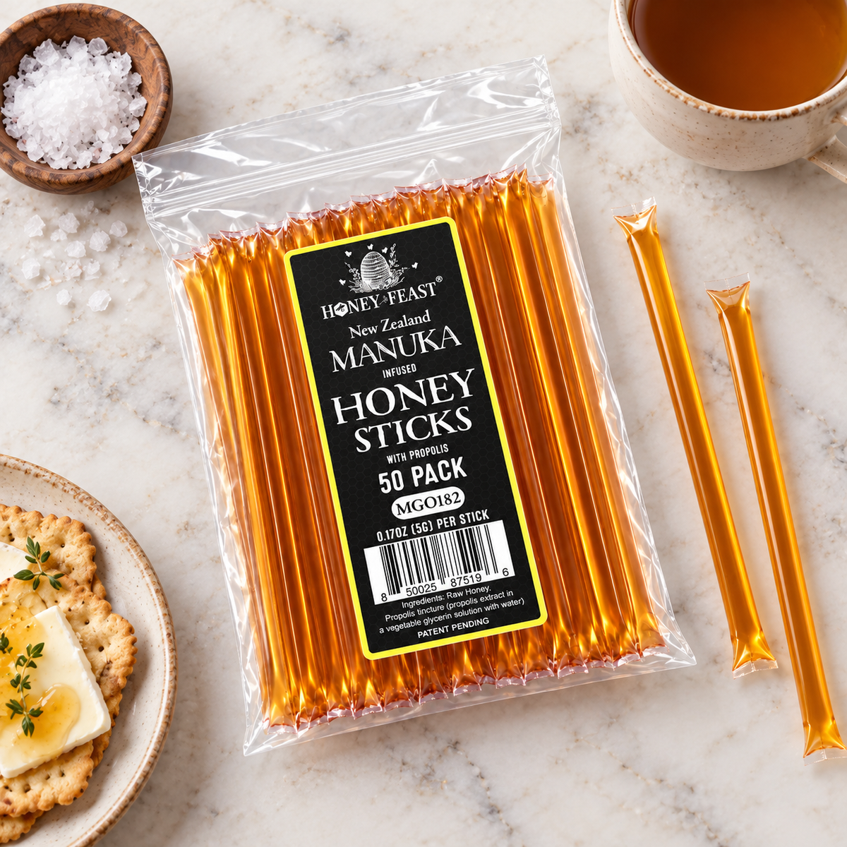 Manuka and Propolis Honey Sticks 50-pack lying flat in a simple serving scene with full-length loose sticks