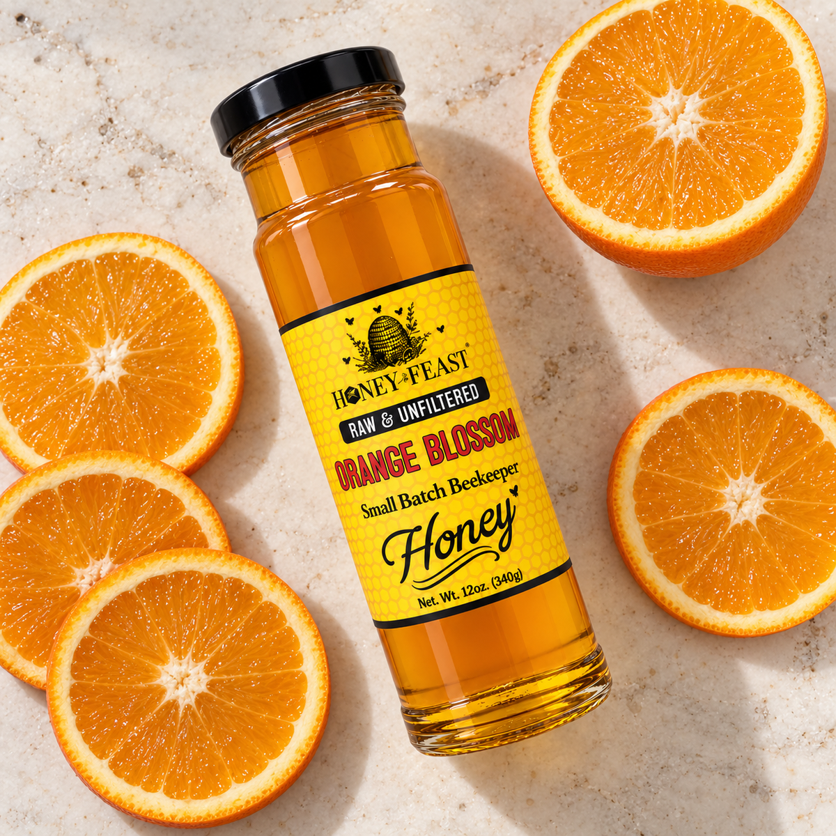 Honey Feast Raw Orange Blossom Honey 12oz glass jar with fresh orange slices
