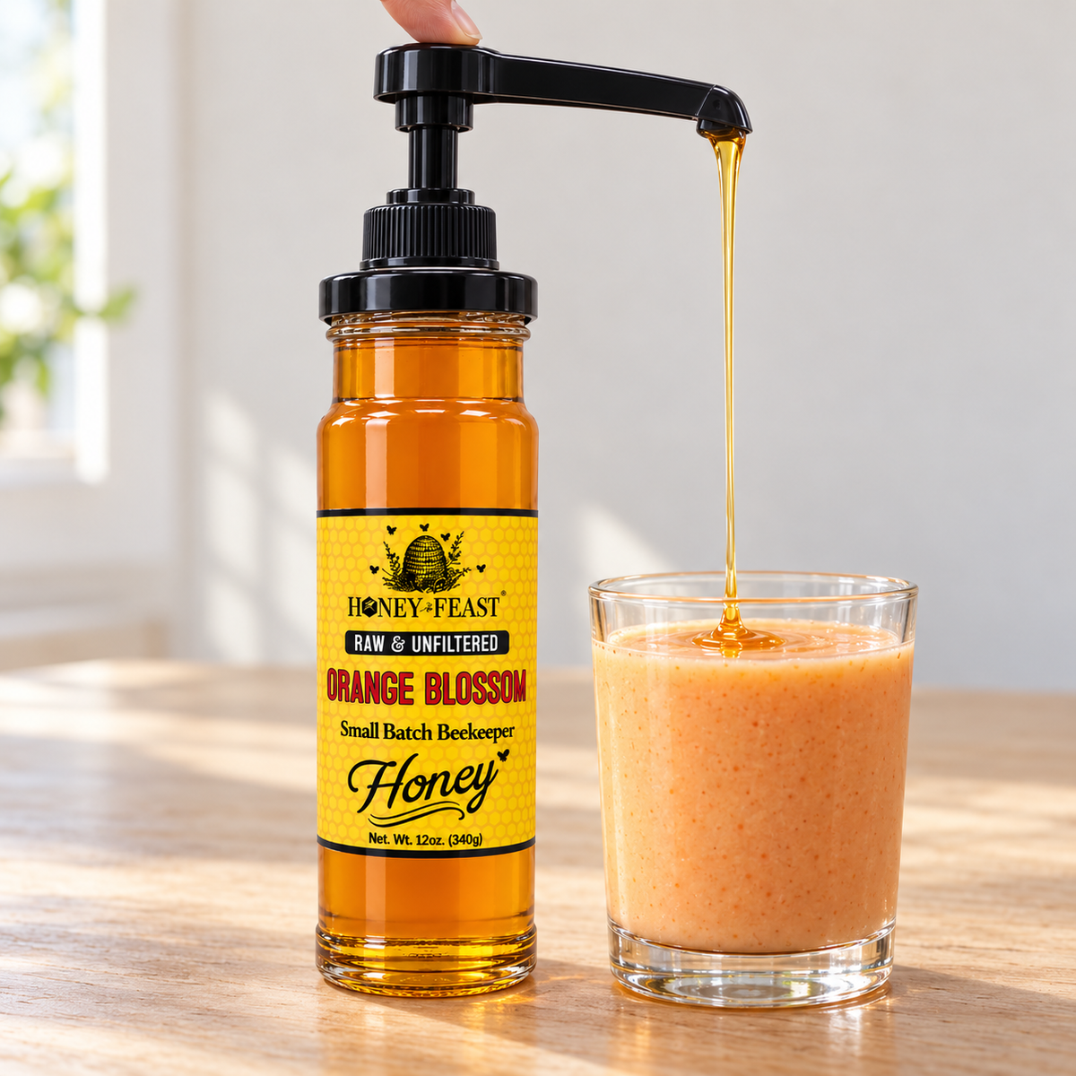 Honey Feast Raw Orange Blossom Honey 12oz glass jar with optional honey pump beside a smoothie; pump sold separately