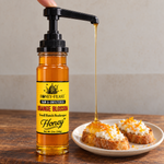 Honey Feast Raw Orange Blossom Honey 12oz glass jar with optional honey pump beside ricotta crostini; pump sold separately