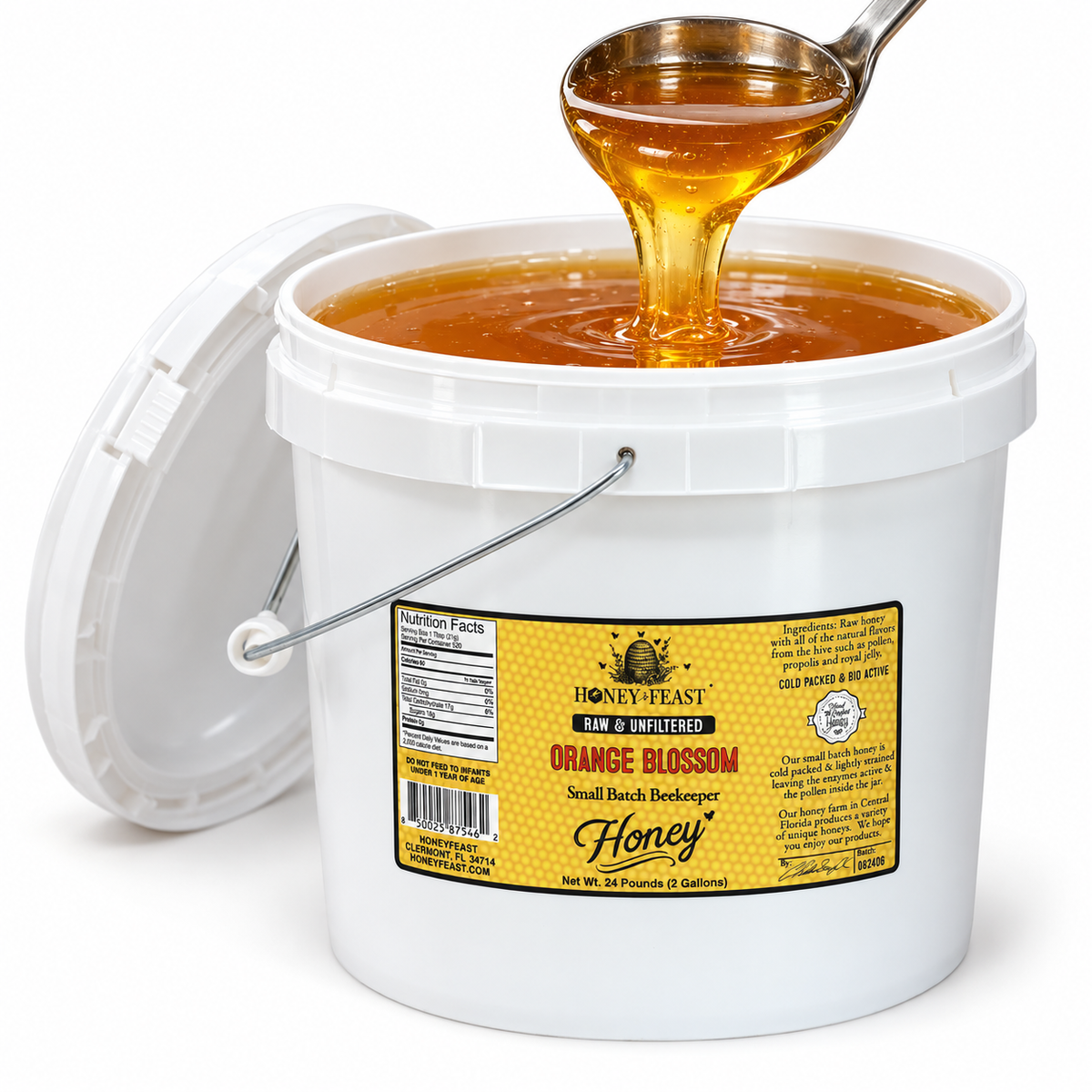 Open Honey Feast Orange Blossom Honey 2-gallon bucket with golden honey flowing from a stainless steel ladle, on a white background.