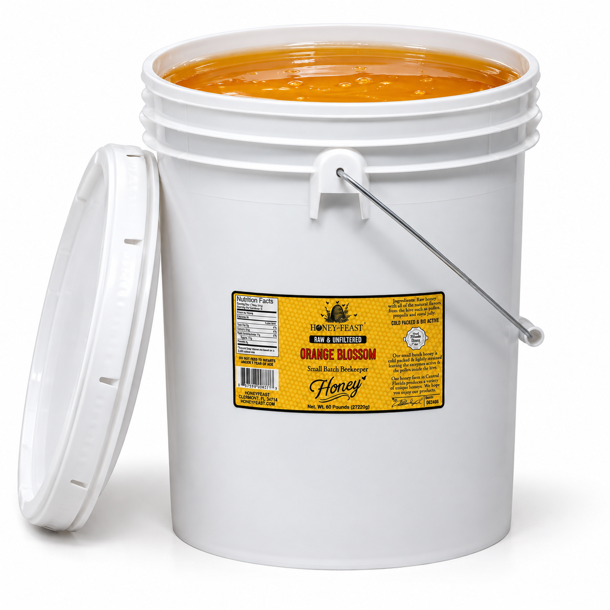 Open Honey Feast Orange Blossom Honey 5-gallon bucket filled with honey, lid removed.