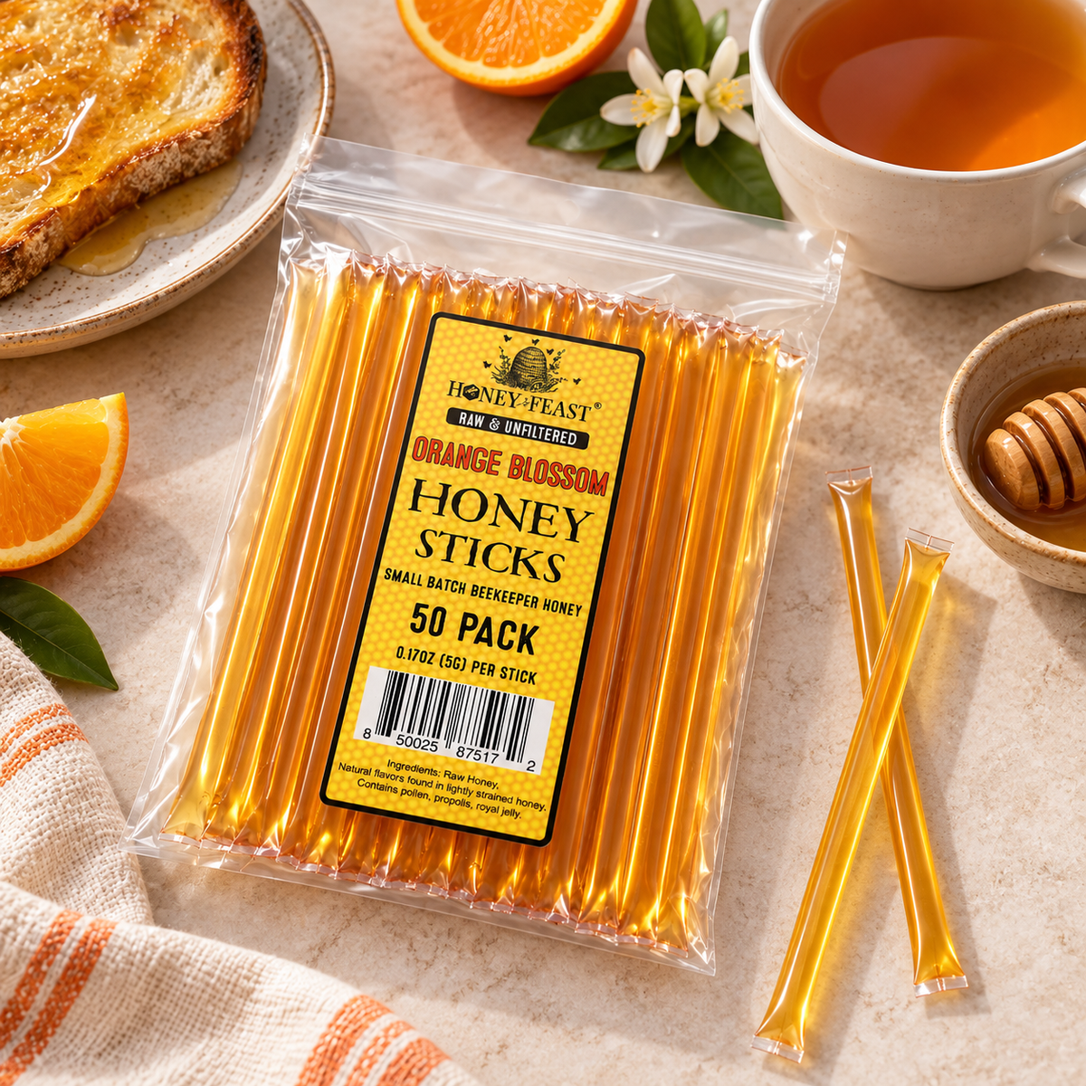 Orange Blossom Honey Sticks 50-pack lying flat in a simple breakfast setting with full-length loose sticks
