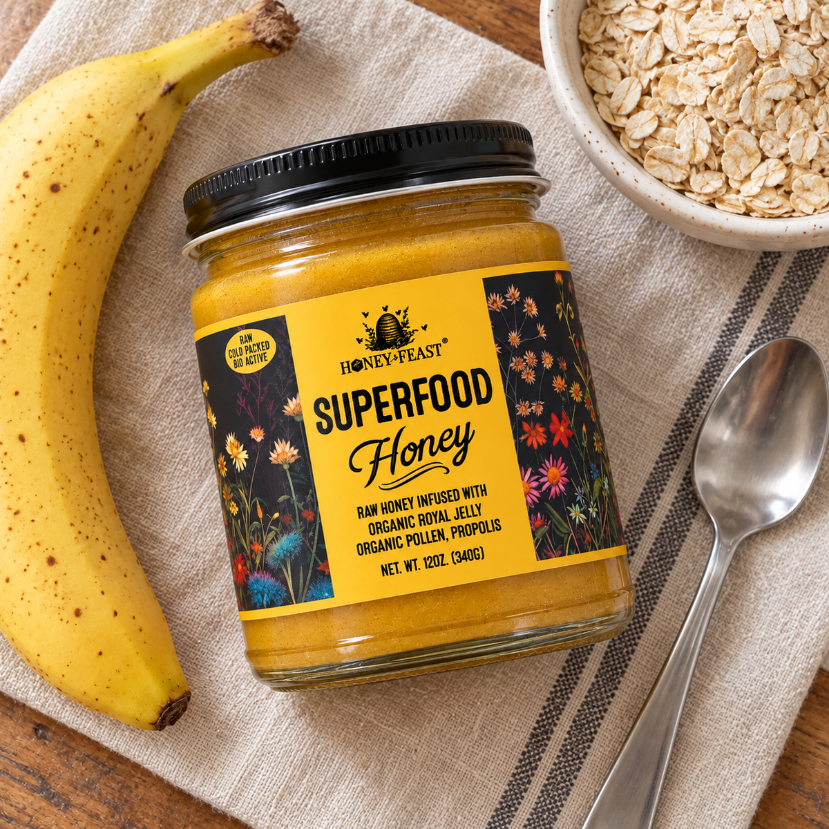 Overhead view of Honey Feast Superfood Honey 12oz glass jar with a banana, oats and a spoon