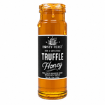 Honey Feast Truffle Honey in an open 12oz glass jar with honey dripping down the side