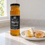 Honey Feast Truffle Honey 12oz glass jar served with a cheese board