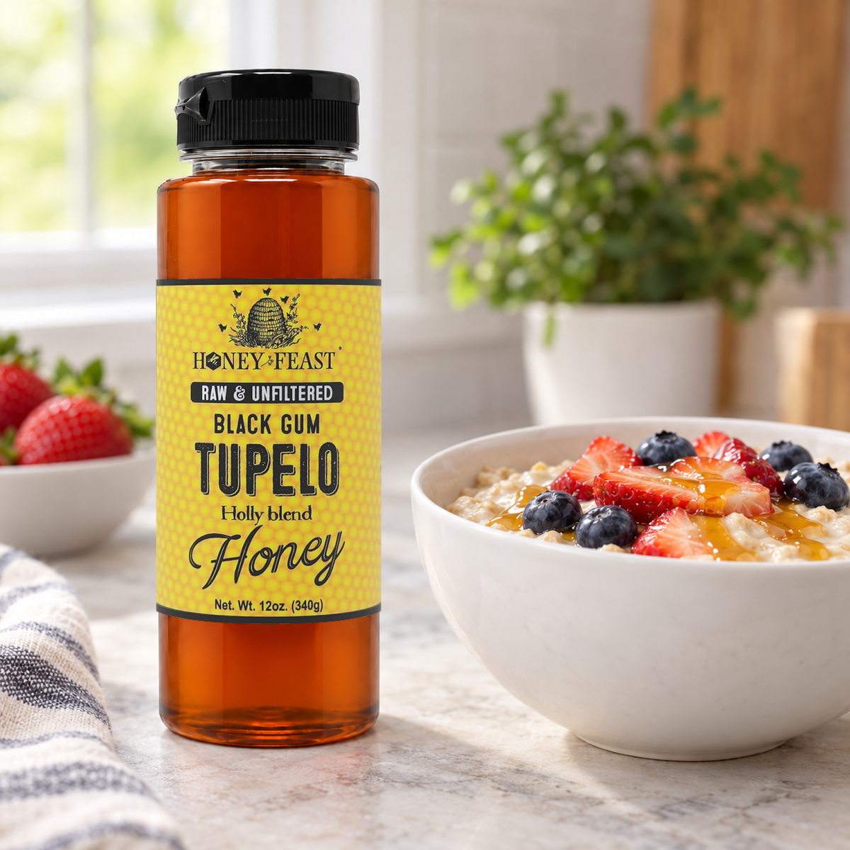Honey Feast Black Gum Tupelo Honey 12oz plastic squeeze bottle beside a white breakfast bowl with strawberries, blueberries and honey