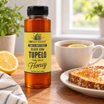 Honey Feast Black Gum Tupelo Honey 12oz plastic squeeze bottle beside lemon tea and toast with honey