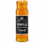 Vanilla infused honey glass jar with lid removed and honey dripping down the jar