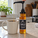 Vanilla honey glass jar with optional honey pump beside coffee