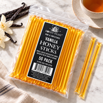 Vanilla Honey Sticks 50-pack lying flat beside vanilla beans and tea with full-length loose sticks