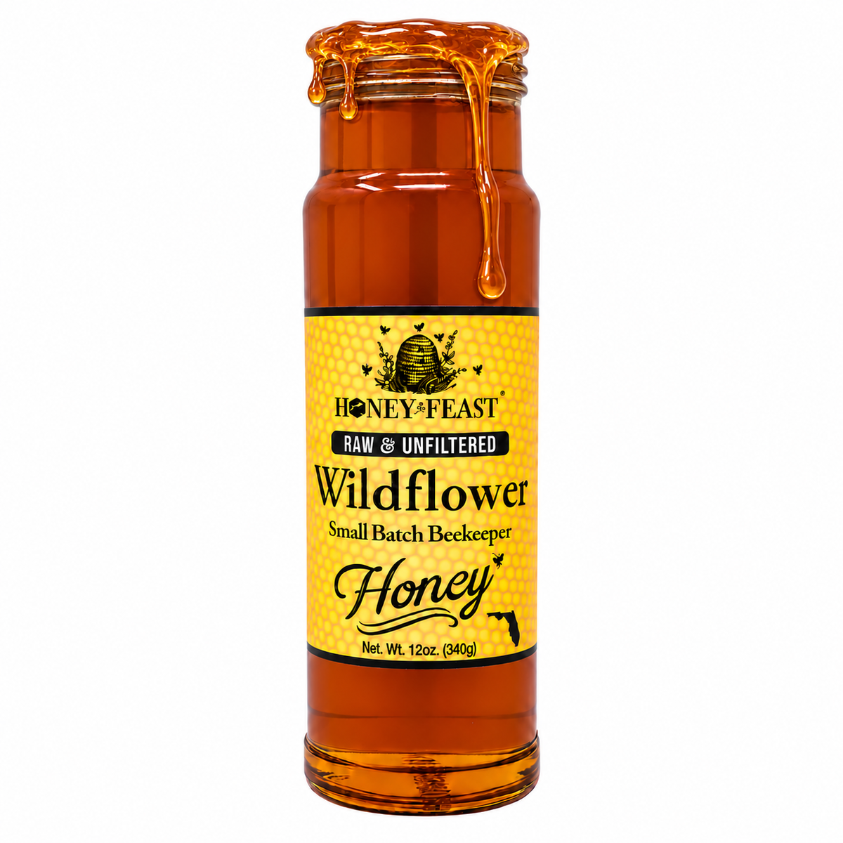 Honey Feast Wildflower Honey in an open 12oz glass jar with honey dripping down the side