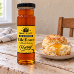 Honey Feast Wildflower Honey 12oz glass jar served with biscuits