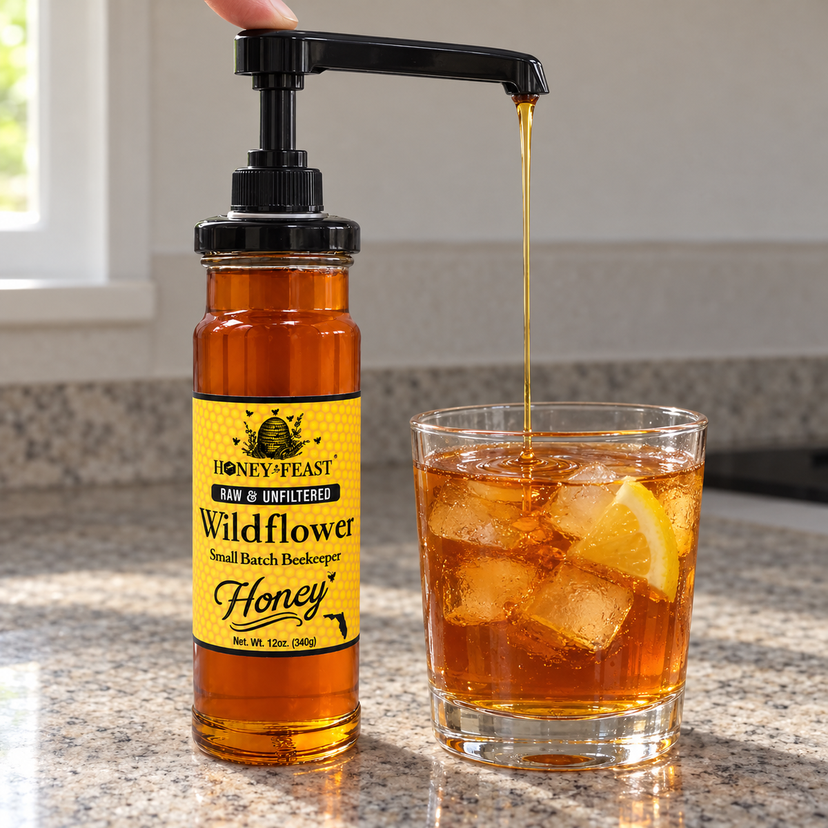 Honey Feast Wildflower Honey 12oz glass jar with optional honey pump beside iced tea; pump sold separately