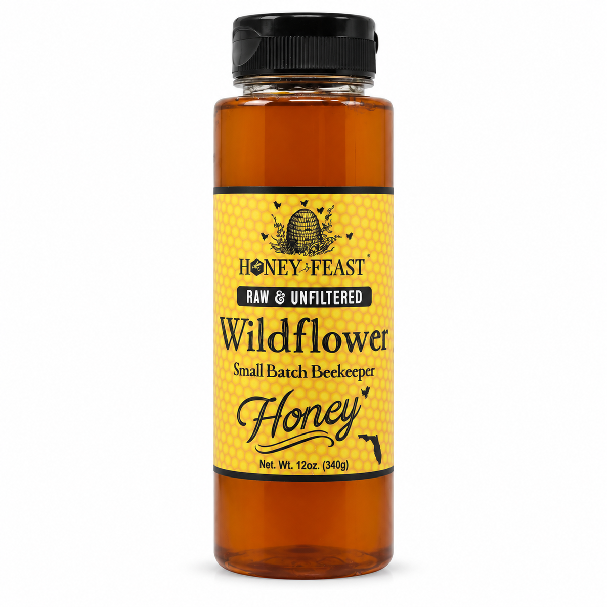 Honey Feast Wildflower Honey 12oz plastic squeeze bottle with the original yellow honeycomb label, on a pure white background