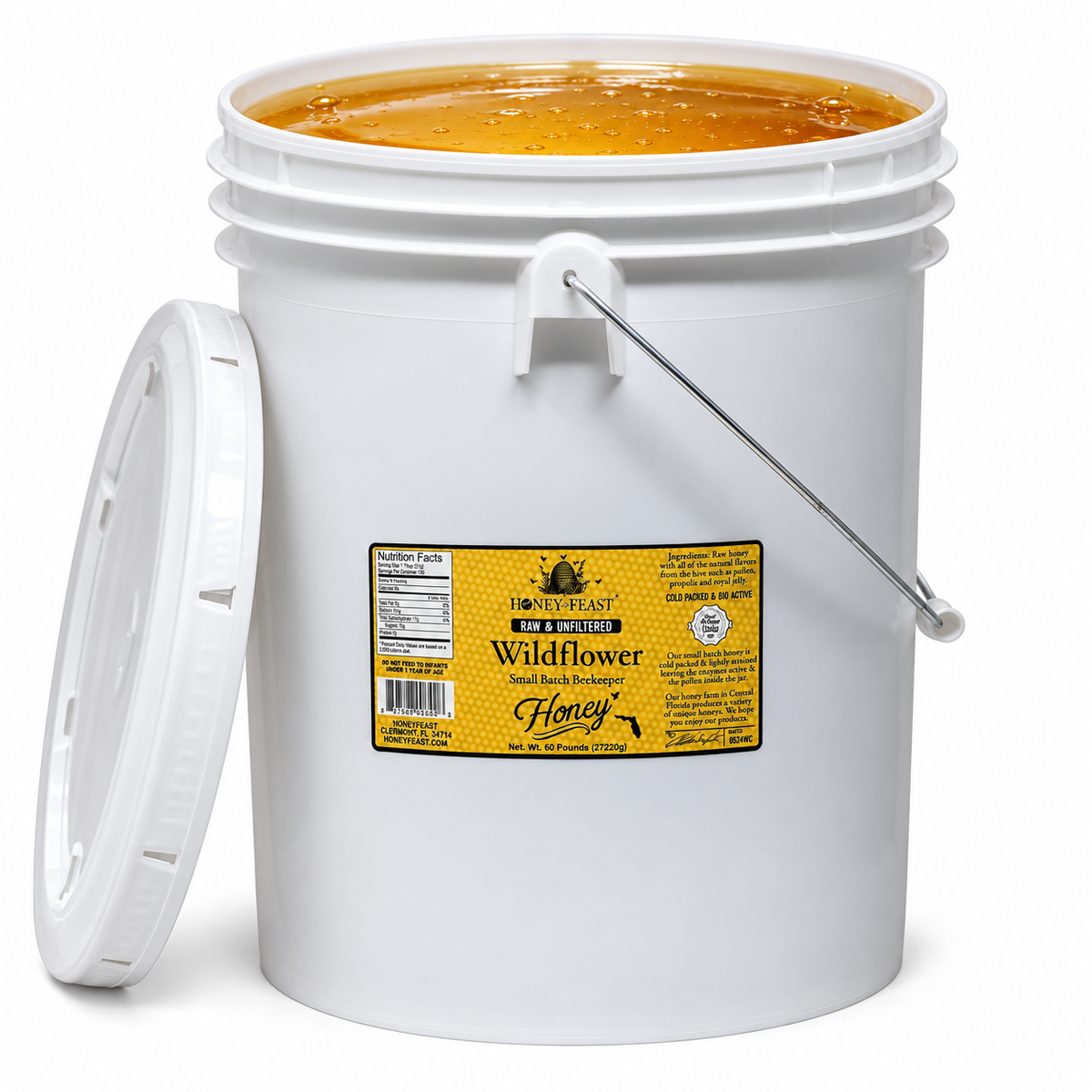 Open Honey Feast Wildflower Honey 5-gallon bucket filled with honey, lid removed.