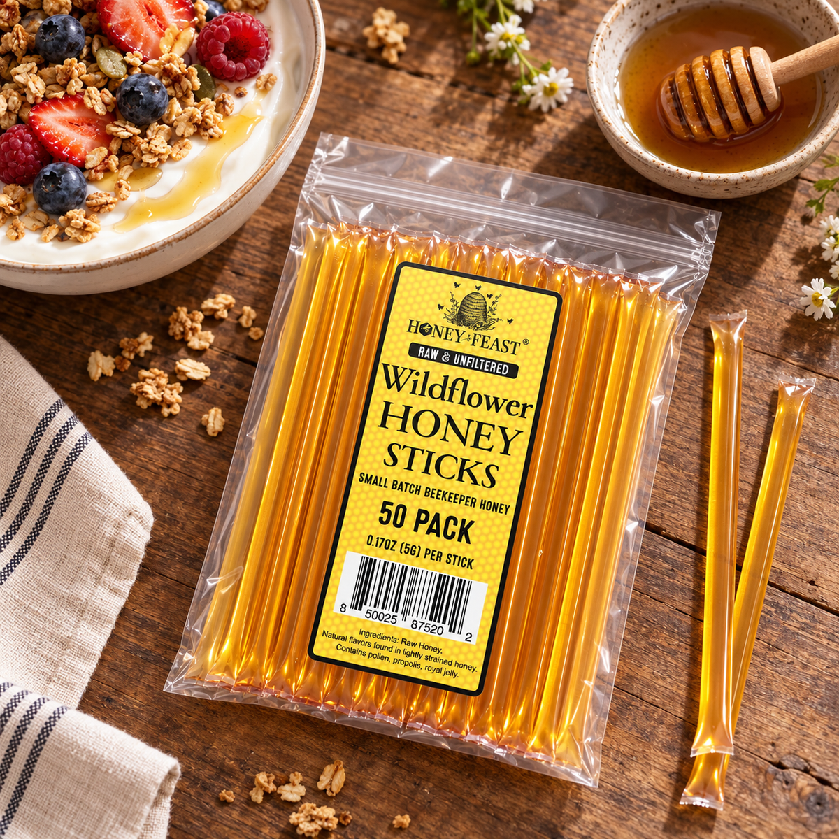 Wildflower Honey Sticks 50-pack lying flat beside yogurt and berries, with full-length loose sticks