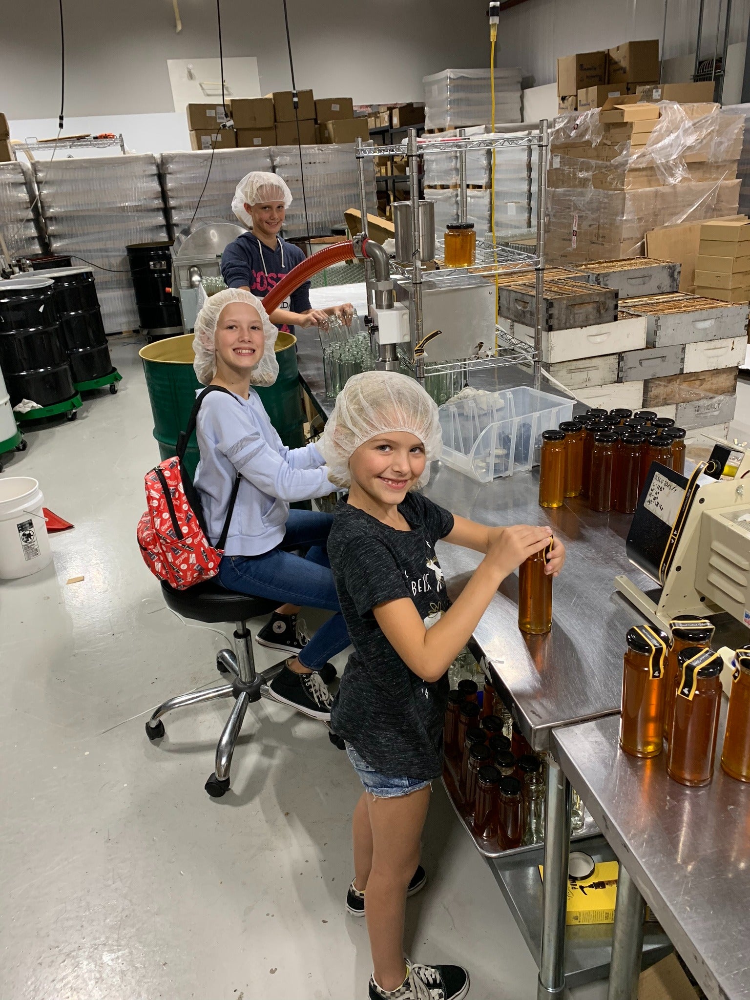 Honey Feast family bottling honey on the farm